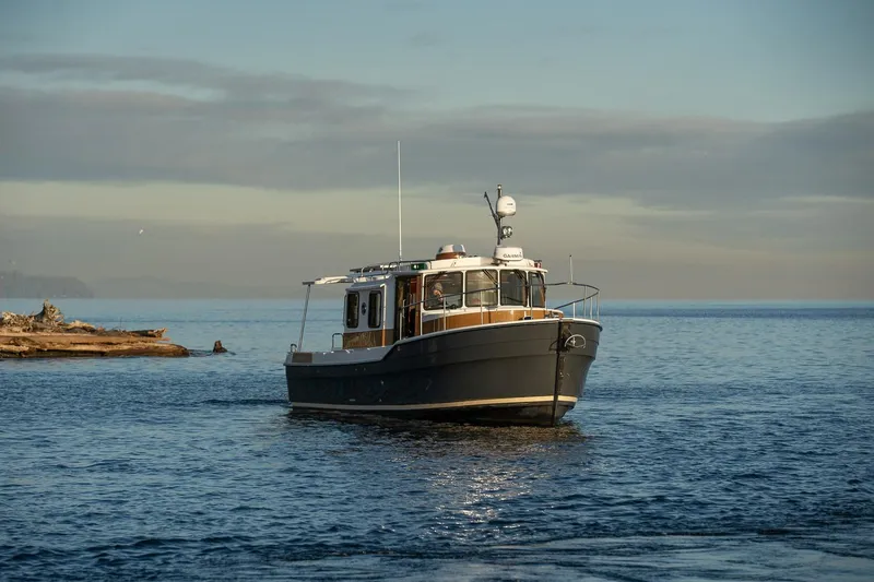 Slide: The Image of 2026 Ranger Tugs R-31S cruising on calm waters at sunset. - 3