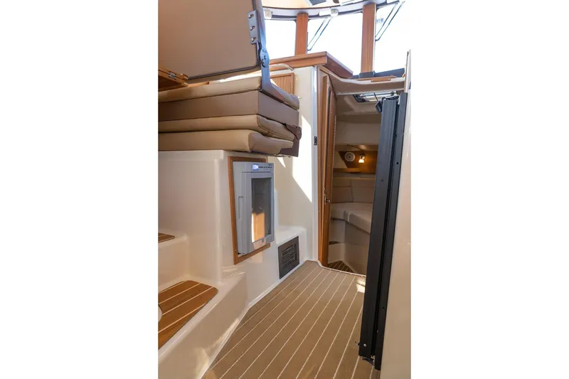 Slide: The Image of Interior of 2026 Ranger Tugs R-31S, featuring compact cabin and seating area. - 38