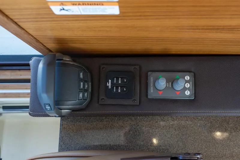 Slide: The Image of Control panel of 2026 Ranger Tugs R-31S boat with joystick and switches. - 40