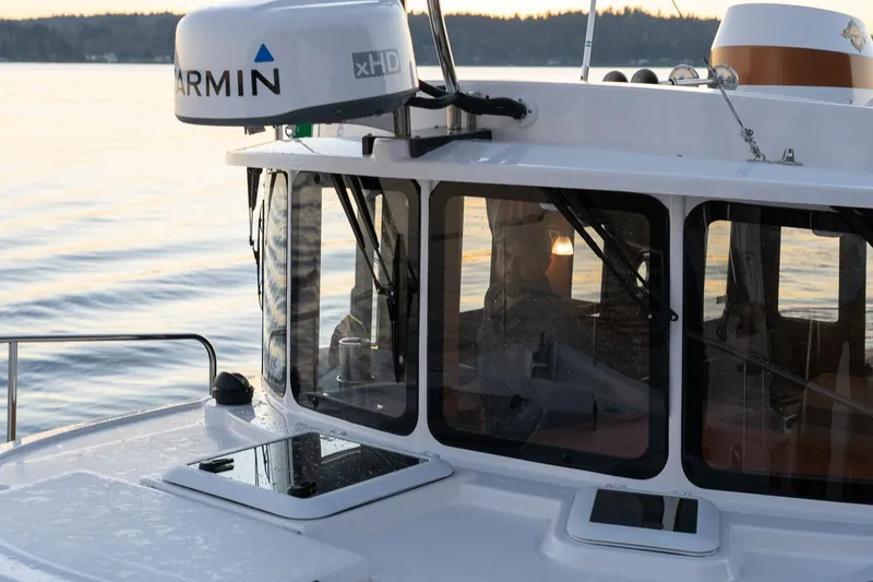 Slide: The Image of 2026 Ranger Tugs R-31S boat with Garmin xHD radar on calm water. - 43