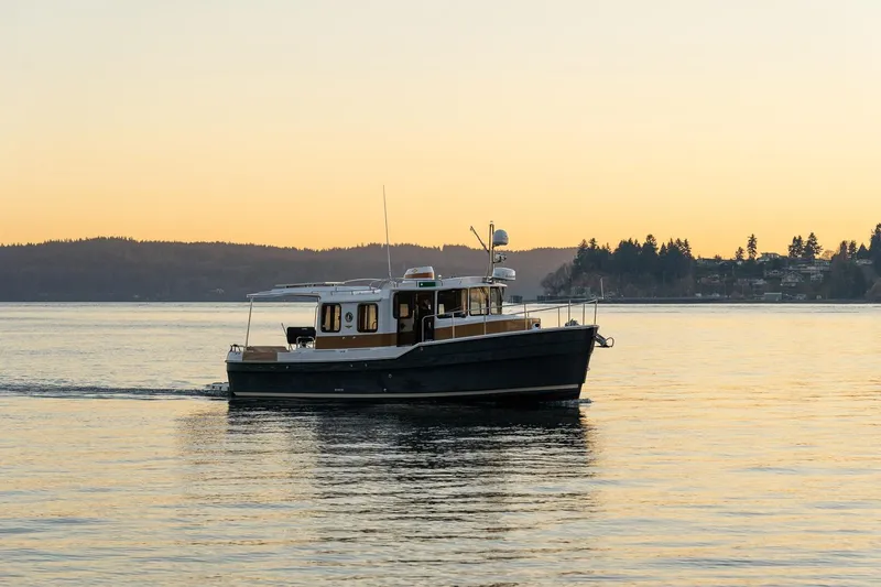 Slide: The Image of 2026 Ranger Tugs R-31S cruising on serene waters at sunset. - 5
