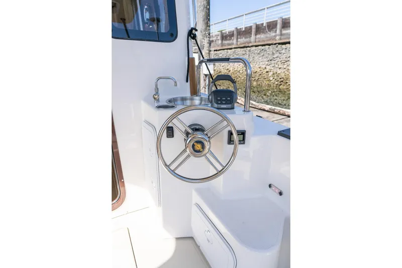 Slide: The Image of Helm station of 2026 Ranger Tugs R-31S with steering wheel and controls. - 9