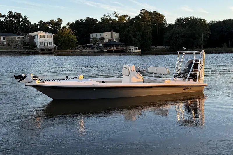 Slide: The Image of 2022 Maverick 18 HPX-V boat on calm water, with houses and trees in the background. - 0