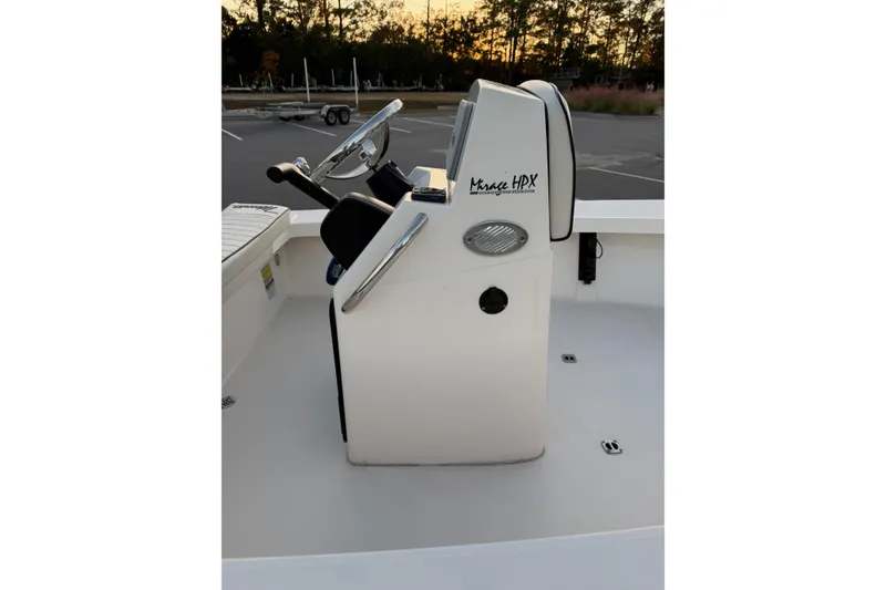 Slide: The Image of 2022 Maverick 18 HPX-V boat console with steering wheel and controls at sunset. - 18