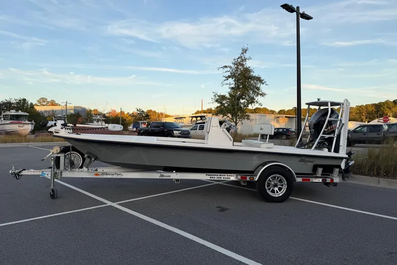 Slide: The Image of 2022 Maverick 18 HPX-V boat on trailer in parking lot, clear sky background. - 2