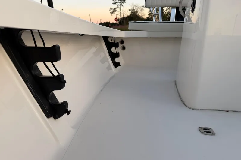 Slide: The Image of 2022 Maverick 18 HPX-V boat interior with rod holders and seating area. - 27