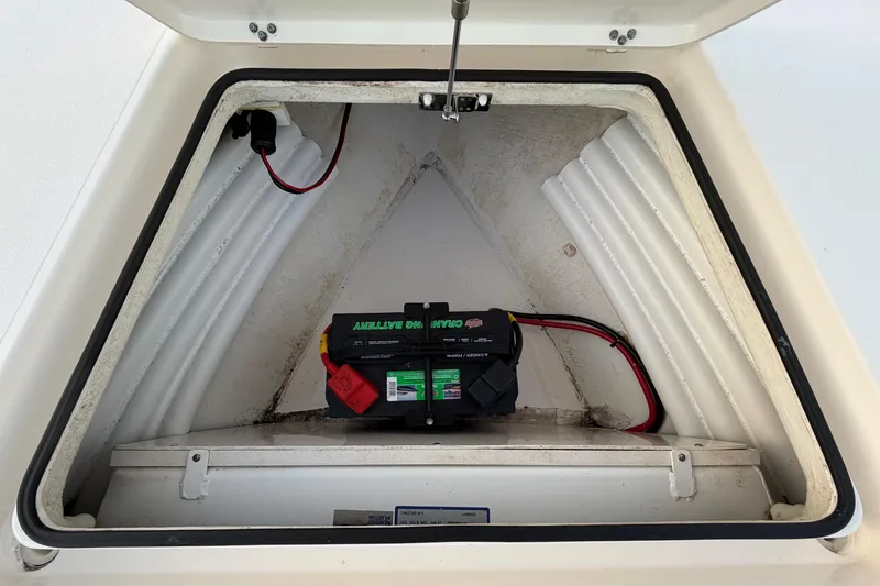 Slide: The Image of Battery compartment of 2022 Maverick 18 HPX-V boat, featuring a marine battery. - 28