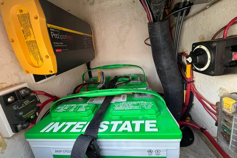 Slide: The Image of Battery compartment of 2022 Maverick 18 HPX-V with Interstate deep cycle battery and ProSport charger. - 31