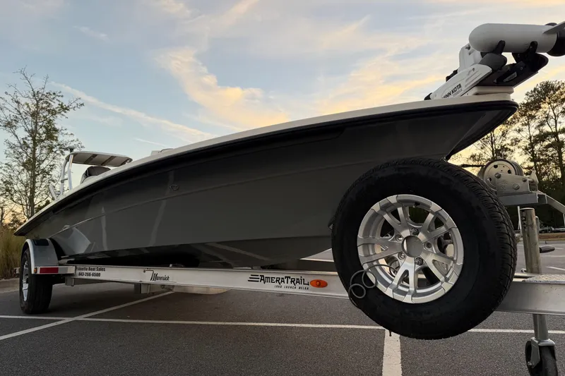 Slide: The Image of 2022 Maverick 18 HPX-V boat on trailer at sunset, showcasing sleek design. - 6