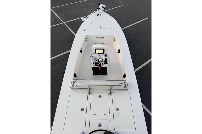 Slide: The Image of 2022 Maverick 18 HPX-V boat interior with steering console in parking lot. - 8