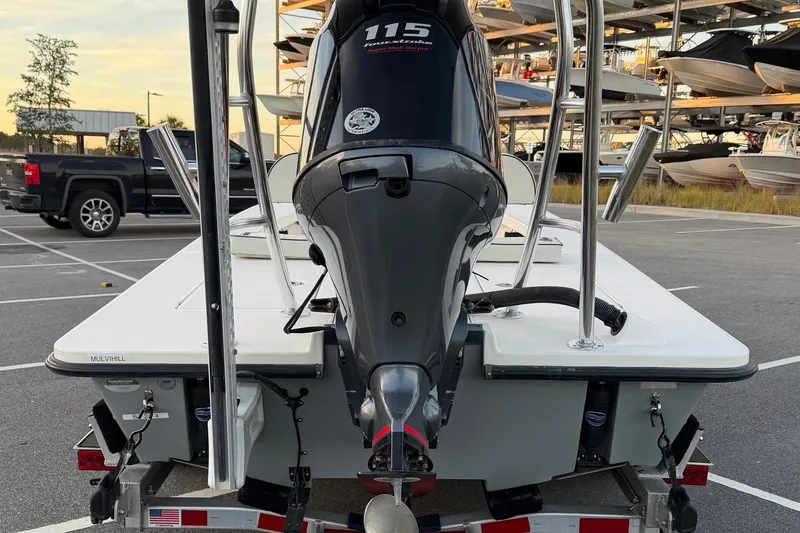 Slide: The Image of 2022 Maverick 18 HPX-V boat with 115 HP engine in a parking lot. - 9