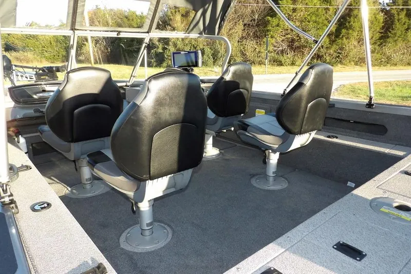 Slide: The Image of 2018 Crestliner 1950 Fish Hawk WT interior with four swivel seats and a navigation screen. - 10