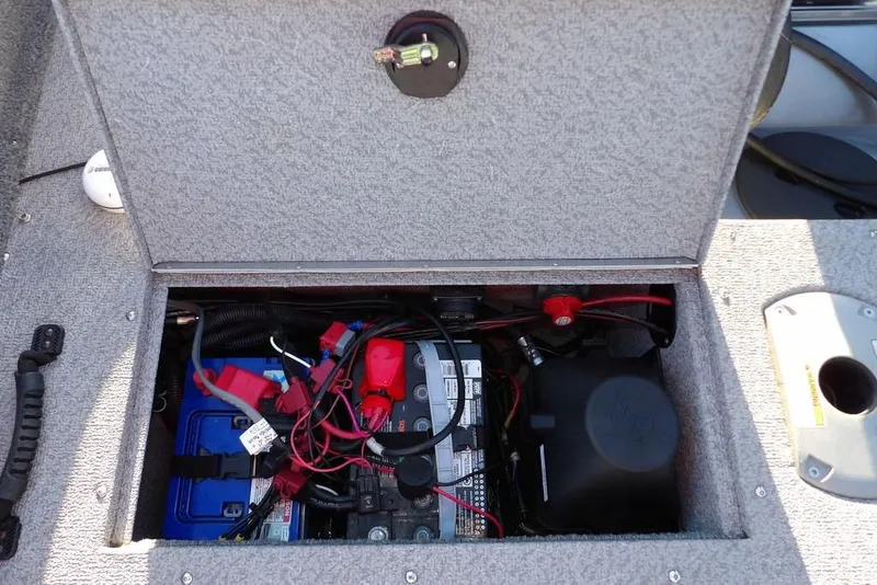 Slide: The Image of 2018 Crestliner 1950 Fish Hawk WT boat battery compartment with wiring and components. - 12