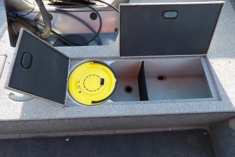Slide: The Image of 2018 Crestliner 1950 Fish Hawk WT boat storage compartments with open lids and yellow container. - 15