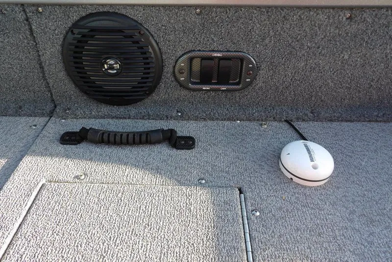 Slide: The Image of 2018 Crestliner 1950 Fish Hawk WT interior with speaker, handle, and electronic device. - 16