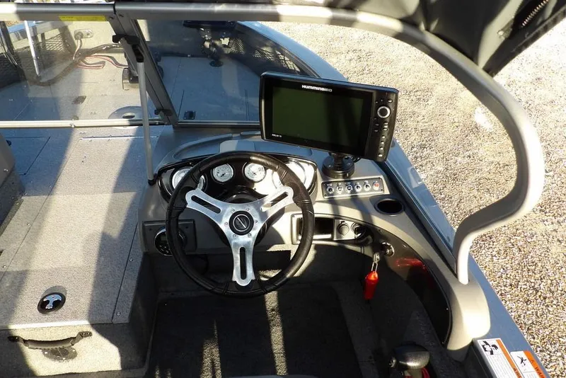 Slide: The Image of 2018 Crestliner 1950 Fish Hawk WT boat dashboard with steering wheel and navigation system. - 25