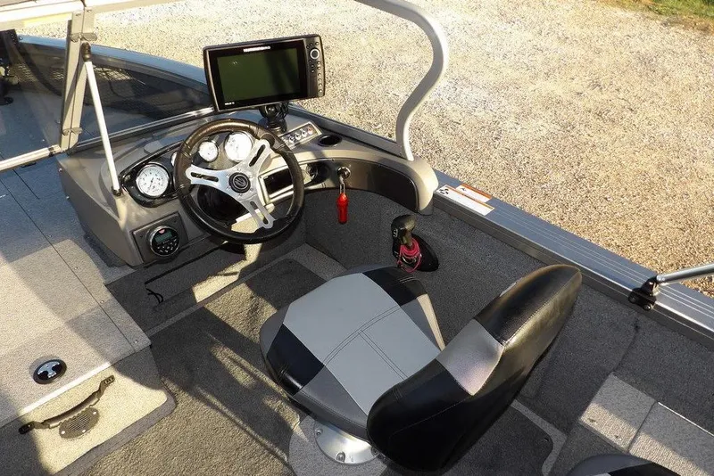 Slide: The Image of 2018 Crestliner 1950 Fish Hawk WT boat interior with steering wheel and navigation system. - 28