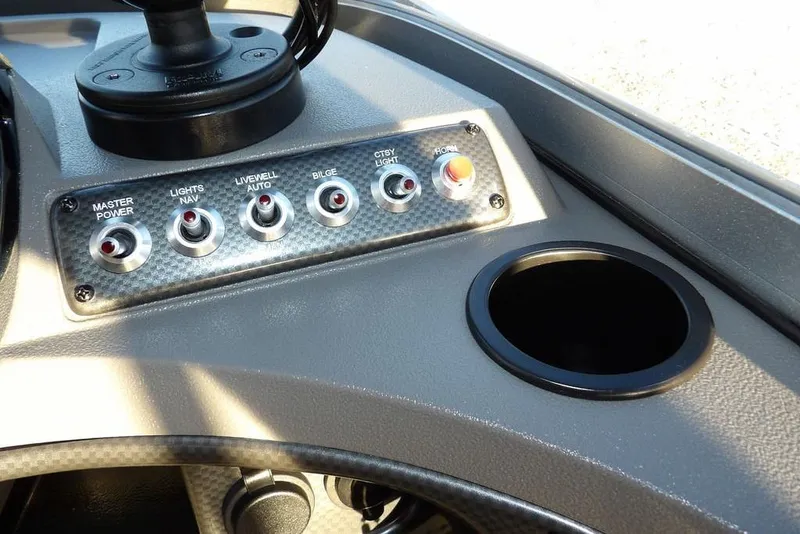 Slide: The Image of Control panel of 2018 Crestliner 1950 Fish Hawk WT boat with switches and cup holder. - 30