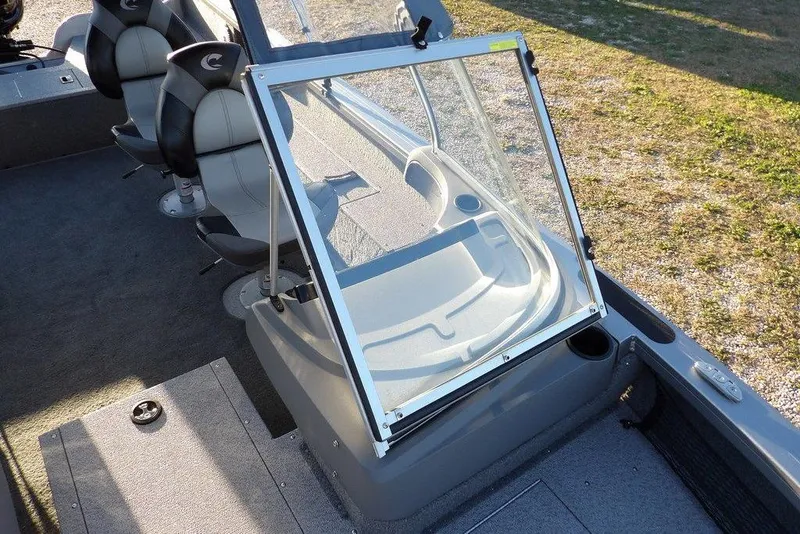 Slide: The Image of 2018 Crestliner 1950 Fish Hawk WT interior with seating and windshield, parked on gravel. - 41