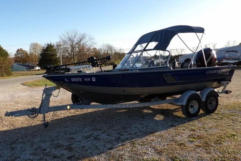 Slide: The Image of 2018 Crestliner 1950 Fish Hawk WT boat on trailer, parked outdoors. - 5