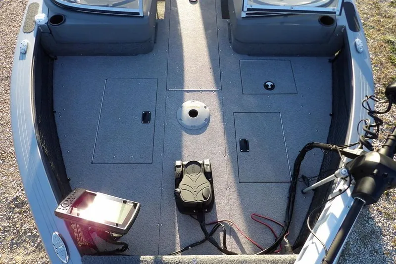 Slide: The Image of 2018 Crestliner 1950 Fish Hawk WT boat interior with fishing equipment and storage compartments. - 60