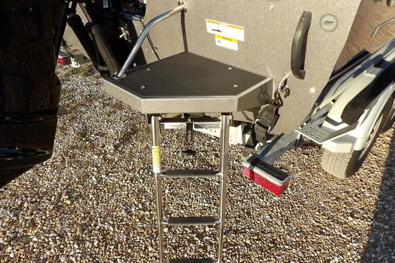 Slide: The Image of 2018 Crestliner 1950 Fish Hawk WT boat ladder and platform on gravel surface. - 62