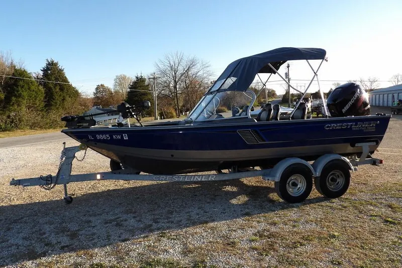 Slide: The Image of 2018 Crestliner 1950 Fish Hawk WT boat on trailer, parked outdoors. - 7