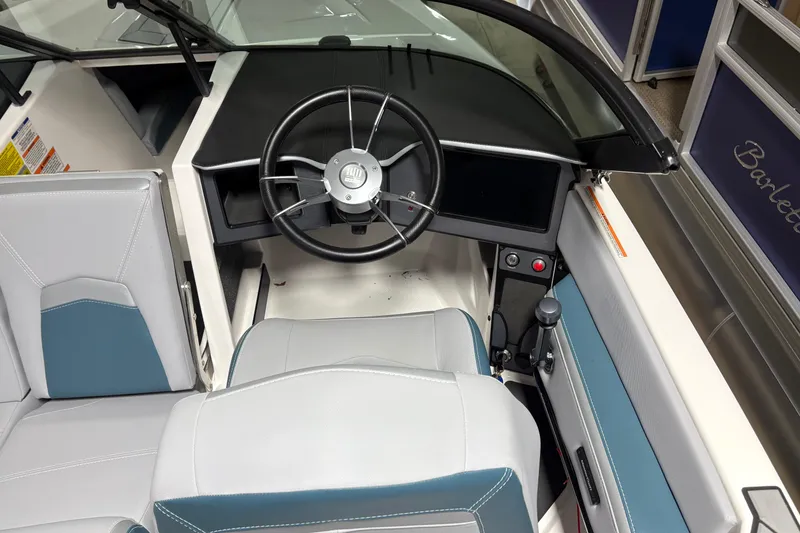 Slide: The Image of 2025 MasterCraft ProStar boat interior with modern steering wheel and sleek dashboard design. - 3