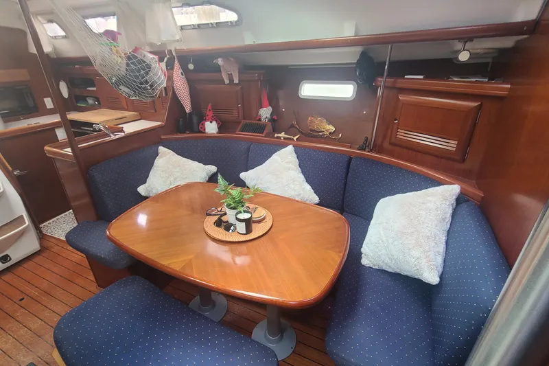 Slide: The Image of Interior of 2005 Beneteau Oceanis 393 yacht kitchen with wooden cabinetry and modern appliances. - 11