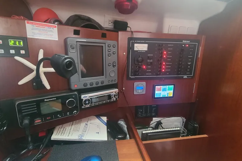 Slide: The Image of Cozy interior of 2005 Beneteau Oceanis 393 sailboat with plush seating and wooden table. - 12