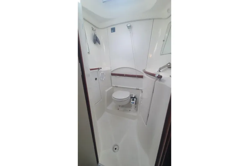 Slide: The Image of Interior cabin of 2005 Beneteau Oceanis 393 yacht with wooden finish and blue upholstery. - 14