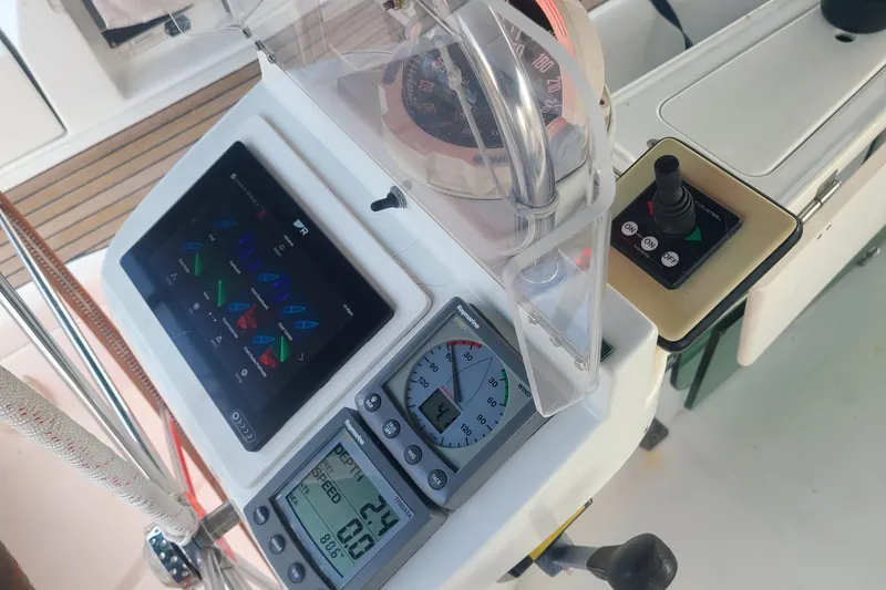 Slide: The Image of 2005 Beneteau Oceanis 393 sailboat cockpit with wheel, seating, and canopy. - 6