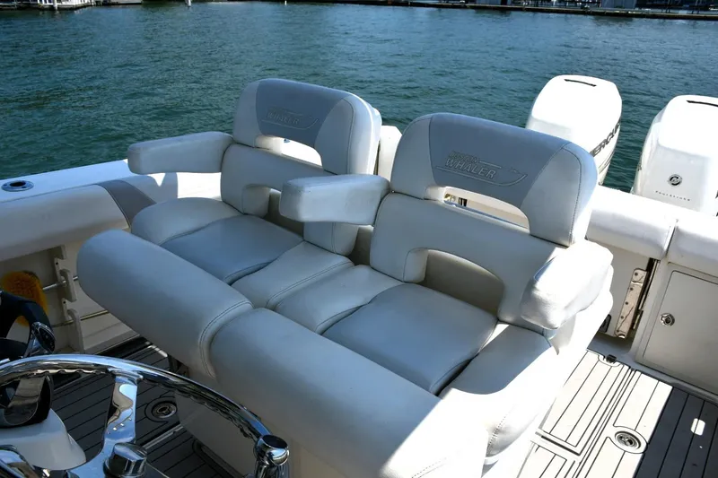 Slide: The Image of Luxury seating on 2016 Boston Whaler 280 Outrage boat, with dual outboard engines. - 14