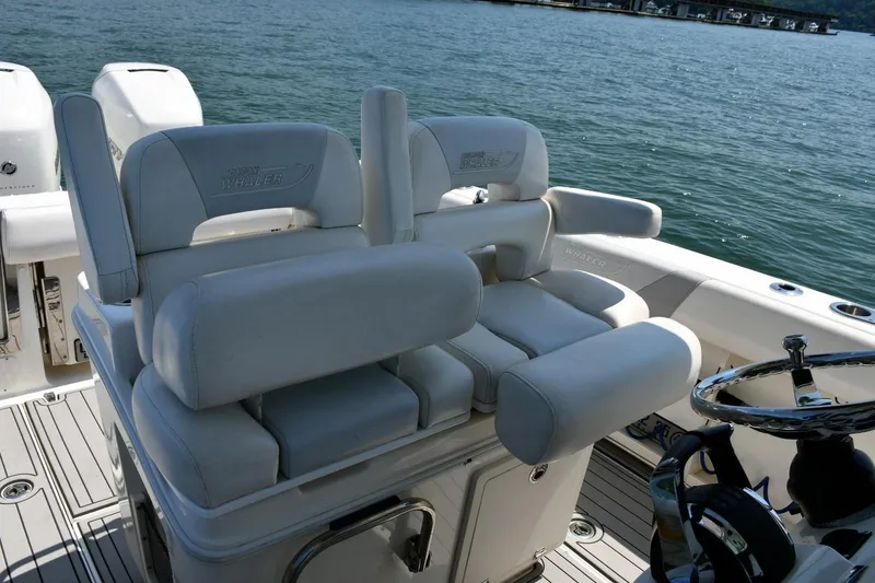 Slide: The Image of 2016 Boston Whaler 280 Outrage boat interior with plush seating and steering wheel. - 15