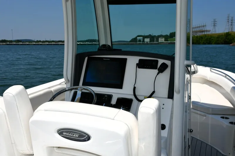 Slide: The Image of 2016 Boston Whaler 280 Outrage boat dashboard with steering wheel and navigation system. - 16