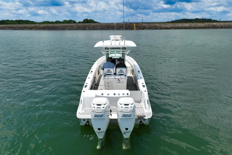 Slide: The Image of 2016 Boston Whaler 280 Outrage boat on water, rear view with twin engines. - 2