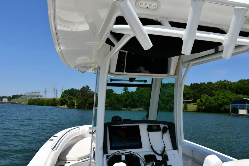 Slide: The Image of 2016 Boston Whaler 280 Outrage boat on a scenic lake with lush greenery. - 21