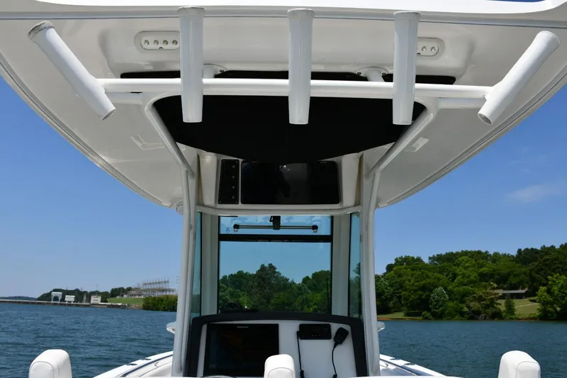 Slide: The Image of Boston Whaler 280 Outrage 2016 boat console with rod holders, on a sunny day. - 22