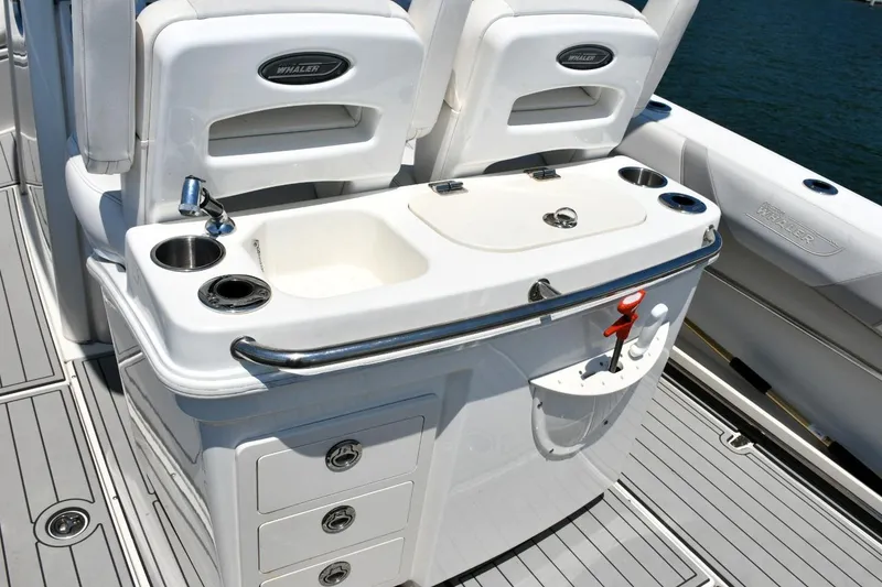 Slide: The Image of Boston Whaler 280 Outrage 2016 boat interior with sink and storage compartments. - 24