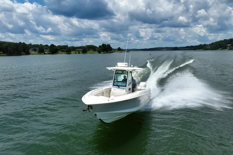 Slide: The Image of 2016 Boston Whaler 280 Outrage cruising on a scenic lake under cloudy skies. - 3