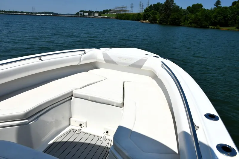 Slide: The Image of 2016 Boston Whaler 280 Outrage boat interior with seating, on a scenic lake. - 8