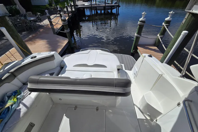 Slide: The Image of 2015 Monterey 315 Sport Yacht at dock, featuring spacious seating and sleek design. - 14