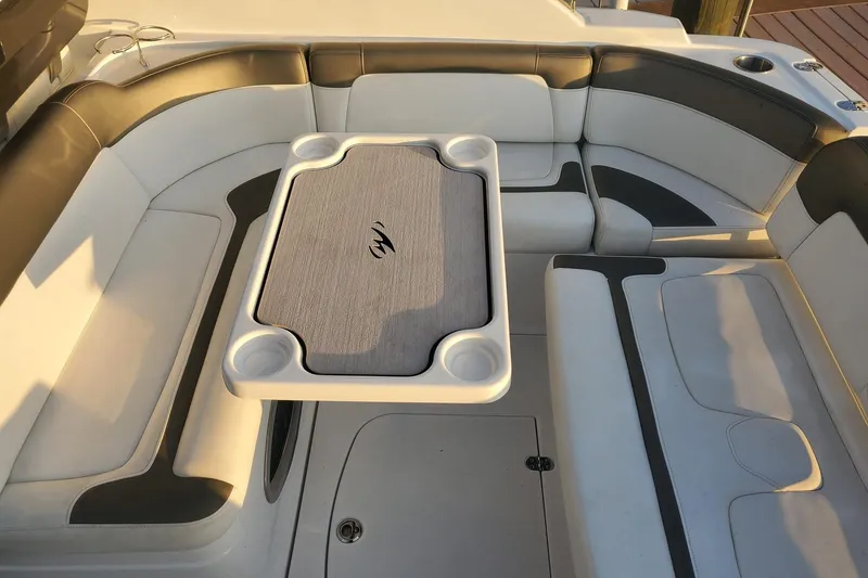 Slide: The Image of 2015 Monterey 315 Sport Yacht interior with cushioned seating and table. - 18