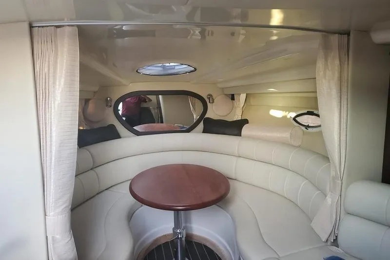Slide: The Image of Interior of 2015 Monterey 315 Sport Yacht with round seating and wooden table. - 22