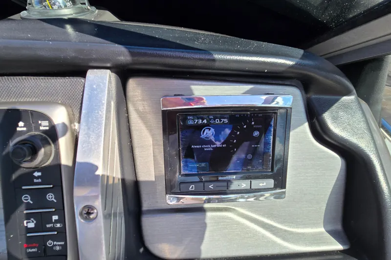 Slide: The Image of Dashboard of a 2015 Monterey 315 Sport Yacht with navigation controls. - 23