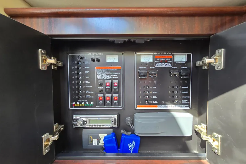 Slide: The Image of Control panel inside 2015 Monterey 315 Sport Yacht, featuring electrical switches and stereo system. - 24