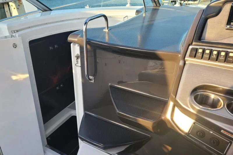 Slide: The Image of Interior view of 2015 Monterey 315 Sport Yacht cockpit with steps and control panel. - 25