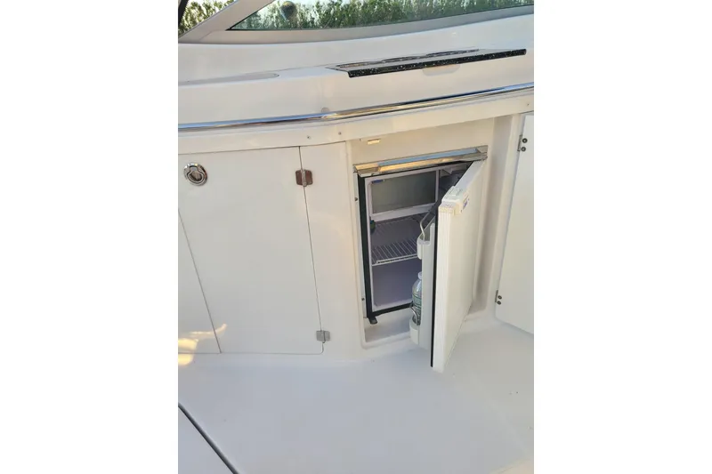 Slide: The Image of 2015 Monterey 315 Sport Yacht mini fridge with open door on deck. - 29