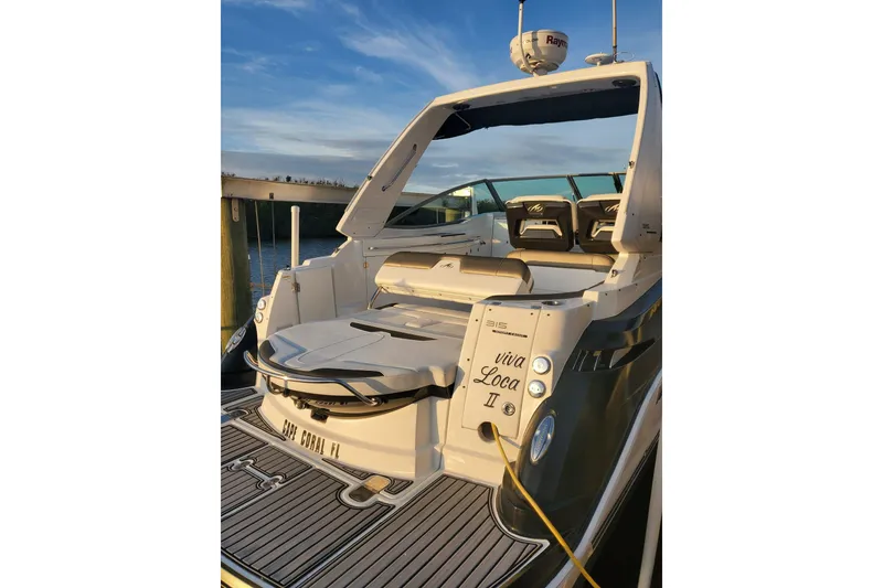Slide: The Image of 2015 Monterey 315 Sport Yacht docked, rear view with seating and "Viva Loca II" name. - 30