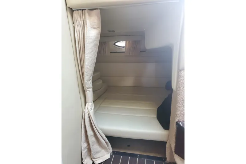 Slide: The Image of 2015 Monterey 315 Sport Yacht interior cabin with bed and curtain. - 31